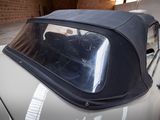 a car that is parked in a garage with its roof down