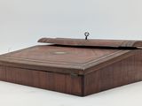an old wooden box sitting on top of a white surface