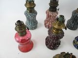 a lot of different colored glass vases on a table