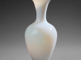 a white vase that is sitting on a table