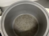 a bowl of water sitting on a counter next to a blender