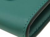 a close up of a green leather wallet on a white background