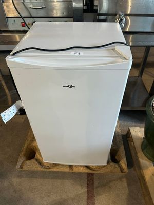 a white refrigerator sitting on a pallet in a warehouse