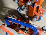 pair of orange and blue jacks sitting on top of a wooden floor