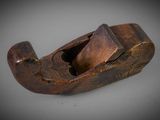 a close up of a wooden plane on a white surface