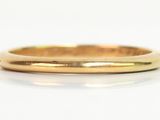a close up of a gold ring on a white surface