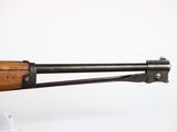 a close up of a rifle with a wooden handle on a white background