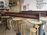 a man sitting at a bar with stools in front of him