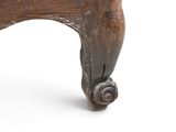a close up view of a wooden chair with wheels on it