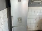 a refrigerator in the corner of a kitchen with tile flooring