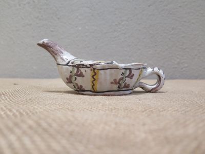 a small bowl with a bird on it on a table