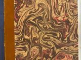 un vieux livre posé sur une table à côté d'une tasse de café