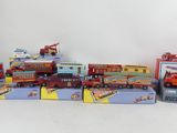 many different types of toy vehicles and trucks on the table