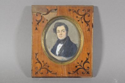 portrait of a man in a black coat in a wooden frame