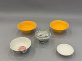 three bowls and two bowls of different colors on a table