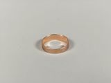 a close up of a gold ring on a white surface