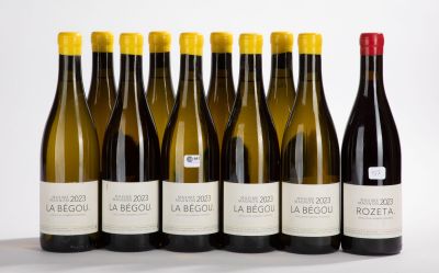 six bottles of wine are lined up in a row on a table