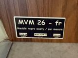 a sign on the door of a building that says mww 26 - tr