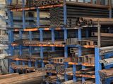 a large rack of steel pipes and pipes in a warehouse