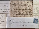 several old letters and envelopes are on a table
