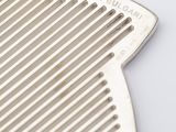 a close up of a comb on a table with a white background