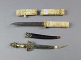 several different types of knives are displayed on a table