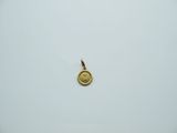a close up of a gold coin on a white surface