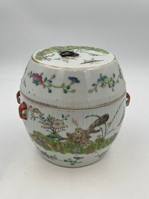 an image of a white and green vase with a bird and flowers on it