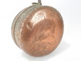 a small metal object that is sitting on a white surface