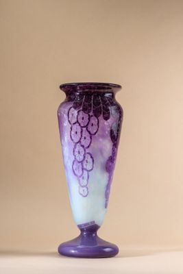 a purple vase sitting on a table with a white background