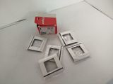 several pieces of white plastic are sitting on a white surface