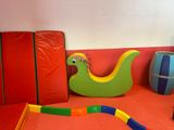 a colorful toy snake in the middle of a play area