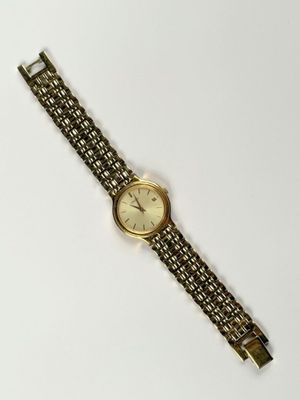 a close up of a watch on a white surface with a white background