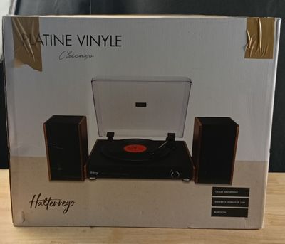 an open box of a record player sitting on top of a wooden table