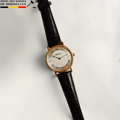 an image of a close up of a wrist watch on a white surface