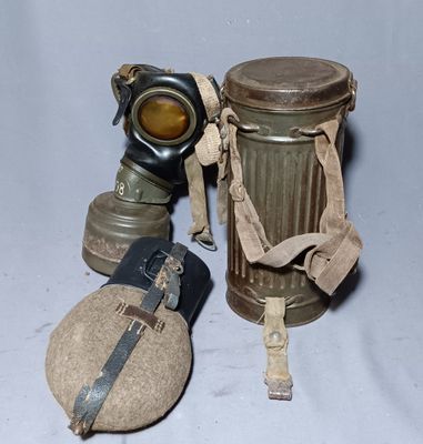 two gas masks and a canister on a table