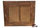 an old wooden frame with a rope hanging on it