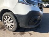 the front end of a white van parked in a parking lot