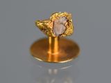 an image of a gold ring with a pink stone in it
