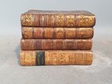 three old books stacked on top of each other on a table