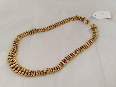 a gold chain necklace with a clasp on a white background