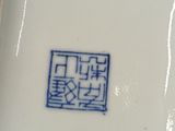 a white plate with a blue and white design on it