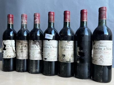 several bottles of wine are lined up on a table