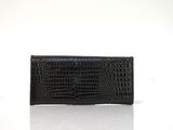 the black crocodile skin wallet purse is on a white surface