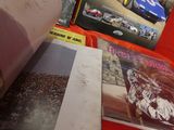 many books that are on a table with a red table cloth