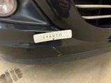 a close up of a car ' s front bumper with a sticker on it