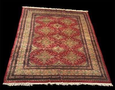 un tapis rouge et or à franges sur fond noir