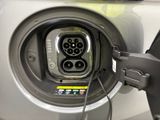 a close up of a car ' s charging station with a car plugged into it