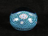 a glass ball with a pattern on it on a black surface