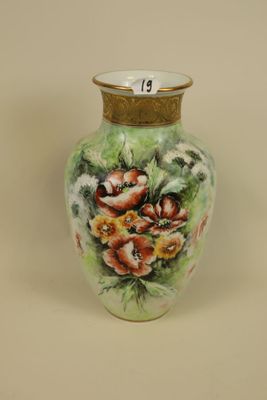a vase with flowers painted on it sitting on a table